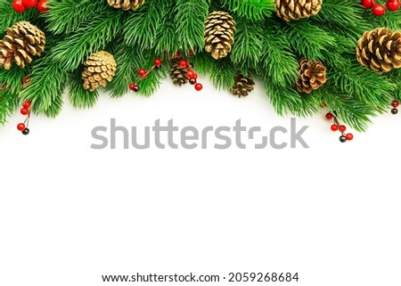 Christmas and New Year background with green spruce branches, cones and red berries, white banner, top view, copy space