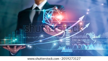 Businessman holding symbol network connection and graph growth of business, Economy and finance on global business, Social media and communication networking. 