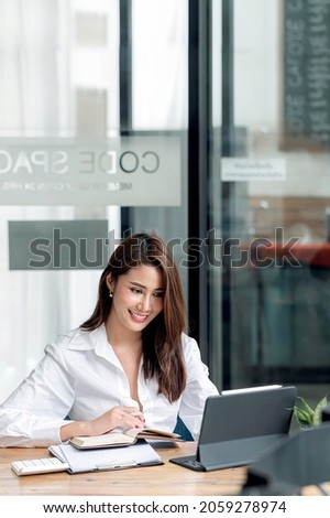 Beautiful asian woman enjoyed working with her small business at home office. Vertical view.