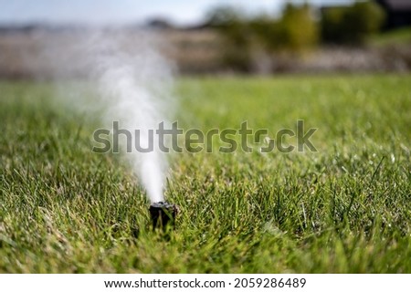 winterizing a irrigation sprinkler system by blowing pressurized air through to clear out water Royalty-Free Stock Photo #2059286489