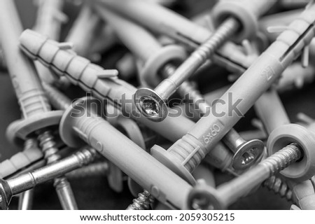 Screws with dowels. Close up. Abstract industrial background.