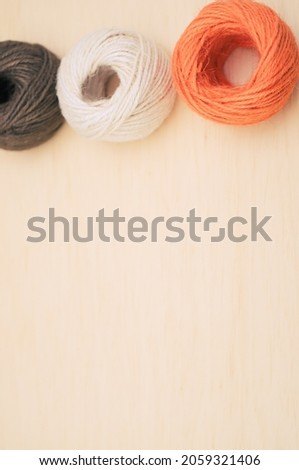 multicolor decoration yarns on a bright wooden background with copy space