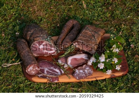 Display of traditional homemade Corsican specialities with cold cuts of coppa, semi wild domestic pic sausage, Figatellu, Lonzu and Pancetta.	