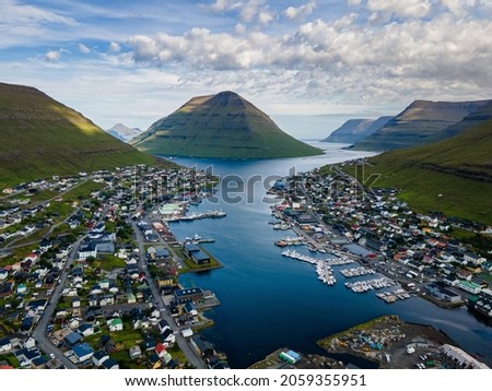Beautiful aerial view of the City of Klaksvik in the Fareo Islands with its colorful houses and amazing canal and view to the majestic Kunoy Park	 Royalty-Free Stock Photo #2059355951