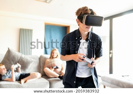 Young boy playing VR game at home