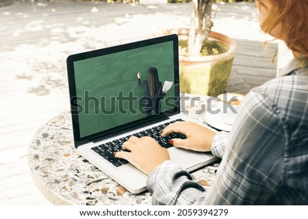 Close up of young casual girl hands using laptop keyboard at wooden cafe table with coffee cup and online education chalkboard and formulas pattern on screen. Digital knowledge and webinar concept