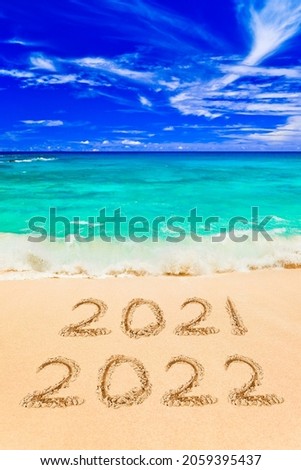 Numbers 2022 on beach - concept holiday background