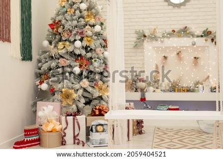 Decorated New Year's blue spruce near the Christmas fireplace with a wreath. Christmas celebration conceptSoft selective focus, art 