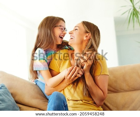 mother and daughter playing and having fun at home