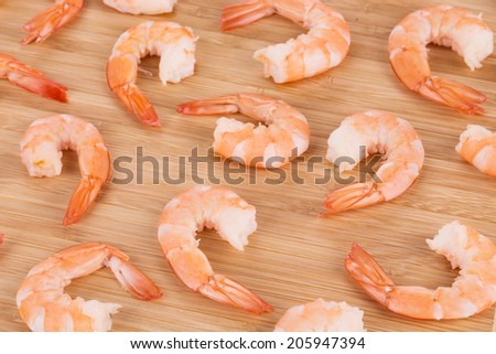 Boiled shrimps on cutting board. Whole background.