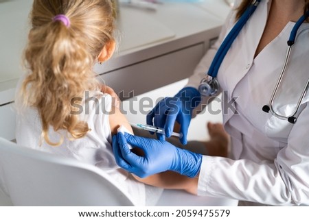 vaccination of children, a little girl at a doctor's appointment, an injection in the arm, the conce Royalty-Free Stock Photo #2059475579