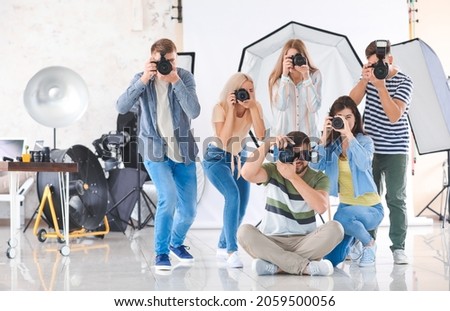 Group of young photographers in studio