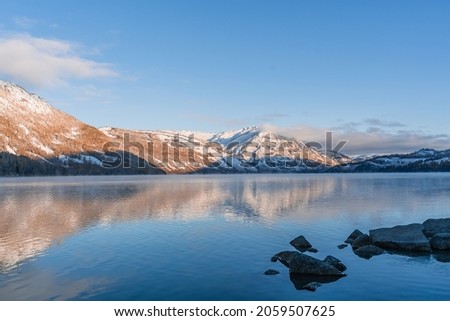 The winter landscape of Kanas lake in Xinjiang province, China, at sunrise.