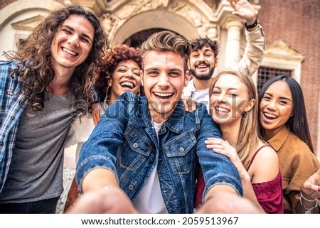 Multicultural best friends having fun taking group selfie portrait outside  - Smiling guys and girls celebrating party day hanging out together on city street - Happy lifestyle and friendship concept