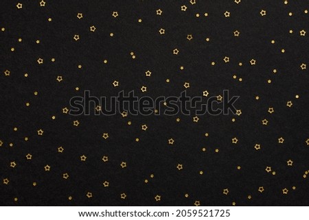 Golden stars on black background. Top view
