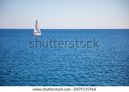 View of small yacht boat sailing in calm open sea in Montenegro . High quality photo