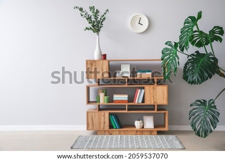 Shelving unit with books and decor in interior of room Royalty-Free Stock Photo #2059537070