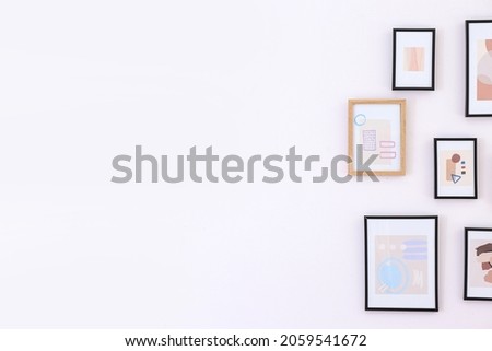 Beautiful pictures hanging on light wall