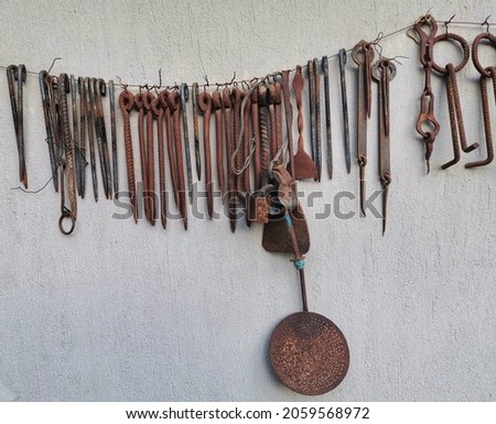 The hardware store. Suspended iron tools and equipment.