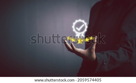 Businessman holding sign of the top service five star Quality assurance, Standard quality control , ISO certification and standardization, Guarantee concept. Royalty-Free Stock Photo #2059574405
