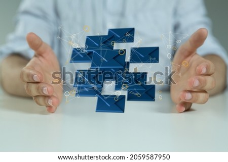 The hands holding rendered mail icons