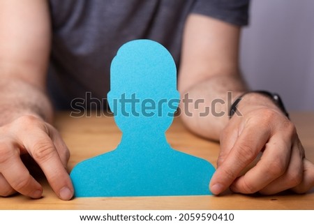 A 3d rendering of a chosen person human symbol in hand on a wooden office