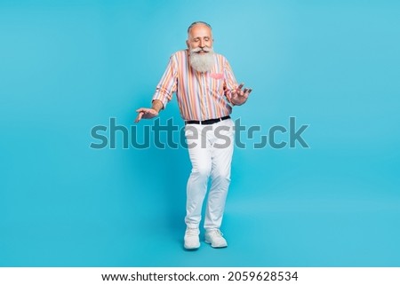Photo of carefree old man enjoy party dance wear striped shirt pants footwear isolated blue color background