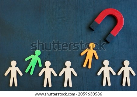 The magnet attracts figures from the crowd. Talent acquisition concept. Royalty-Free Stock Photo #2059630586