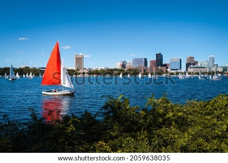 Boston landscape over Charles River with red and white yachts. Tranquil River scape from Charles River Esplanades.