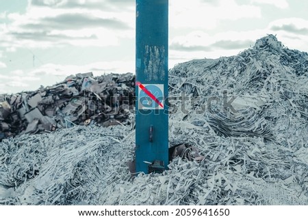 Photo of rubbish and garbage in the dump with the sign of no smoking.