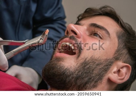 Young boy being seen at a dentist's office. Concept of toothache, tooth extraction, anesthesia, problems with cavities or gums. Oral health care. Dentist's day. Royalty-Free Stock Photo #2059650941