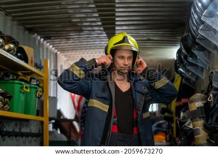 Portrait of a fireman wearing firefighter turnouts and helmet,Firefighter hat and protection gears.