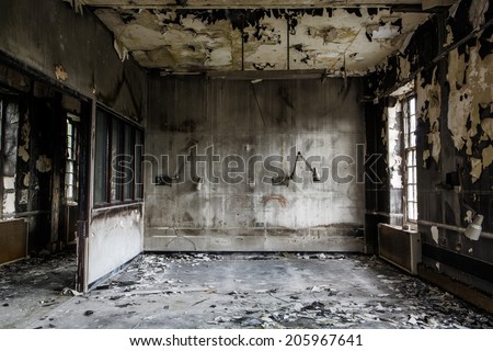 inside view of a deserted run down building after a fire Royalty-Free Stock Photo #205967641