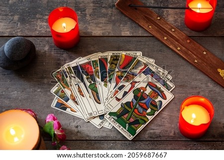 Tarot cards on wooden table with candles. Top view Royalty-Free Stock Photo #2059687667