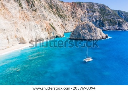 Aerial shots of famous tourist location of paradise beach in Lefkada, Greece. Luxury yacht boat in Porto Katsiki legendary cliffs and views of breathtaking seascapes.