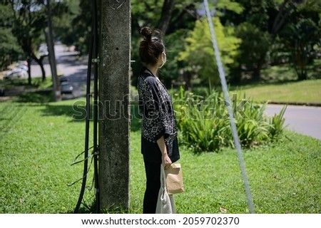 Series photo of young women waiting something in a public park