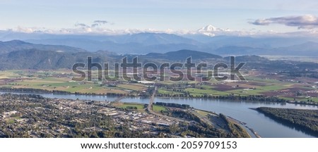 Aerial View of Mission City, Fraser River and Mnt Baker in background. Located East of Vancouver, British Columbia, Canada. Royalty-Free Stock Photo #2059709153
