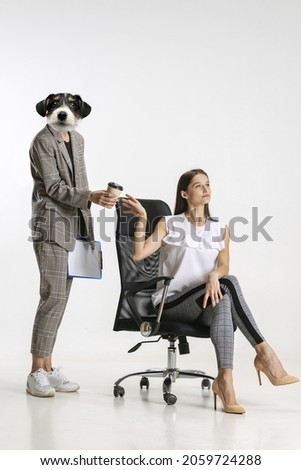 Creative artwork of two female employees, personal assistant with dog head giving cup of coffee to her boss isolated on white background. Concept of business, motivation, career. Copy space for ad