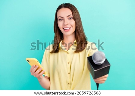 Photo of cute millennial brunette lady take interview hold telephone wear yellow top isolated on teal color background Royalty-Free Stock Photo #2059726508