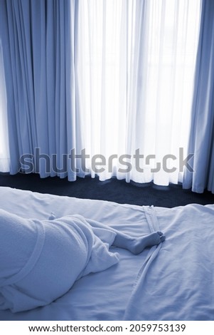 Woman alone in hotel bedroom book cover design photo.