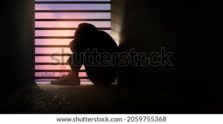 Mental Health Disorder Concept. Weak, Down Depressed Person Sitting on the Floor by the Window. Negative Emotion and Feeling.Dark light Royalty-Free Stock Photo #2059755368