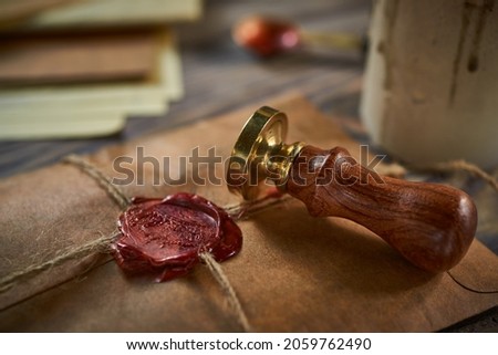 Sealing wax on ancient papers, antique stamp, and old documents, brass spoon  Royalty-Free Stock Photo #2059762490