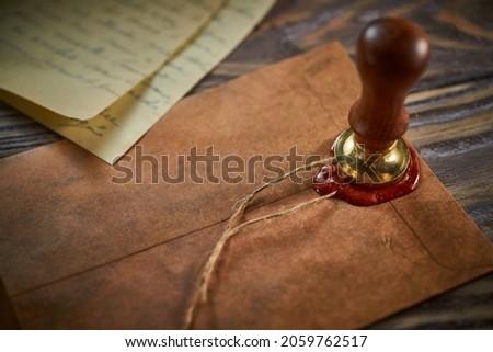 Sealing wax on ancient papers, antique stamp, and old documents, brass spoon  Royalty-Free Stock Photo #2059762517