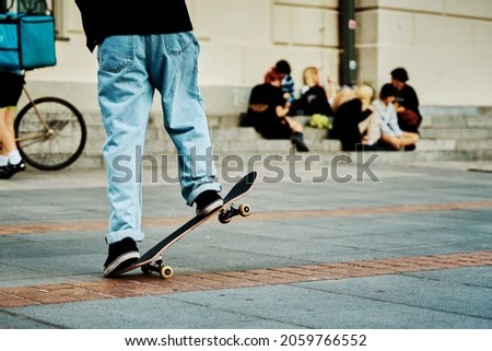 Skateboarder ride on skateboard at city street. Scater practice skate board tricks at skatepark. Teenager extreme sport