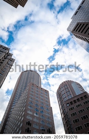 Abstract architectural landscape of tall round buildings on cloudy blue sky in downtown Boston, Massachusetts