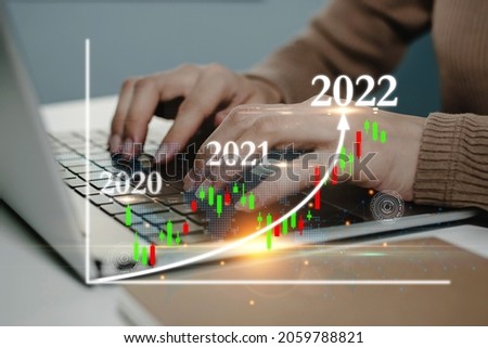 business woman using laptop computer working business financial with virtual graphic graph chart diagram, stock market, investment, digital technology, trading statistics and business strategy concept