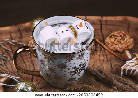 marshmallow snowman in a coffee cup with christmas decor