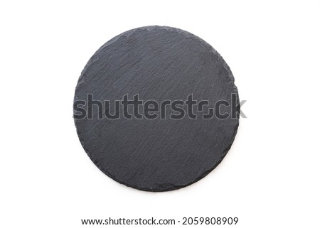 Round slate plate, black slate board isolated on white. Top view Royalty-Free Stock Photo #2059808909