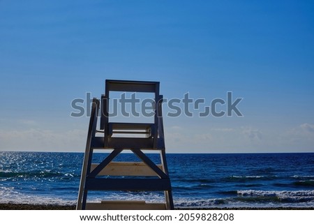 A lifeguard's chair on a beautiful empty beach at sunset in summer.