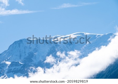 View from Saint-Gervais-les-Bains to white top of Mont Blanc mountain range in summer, French Alps